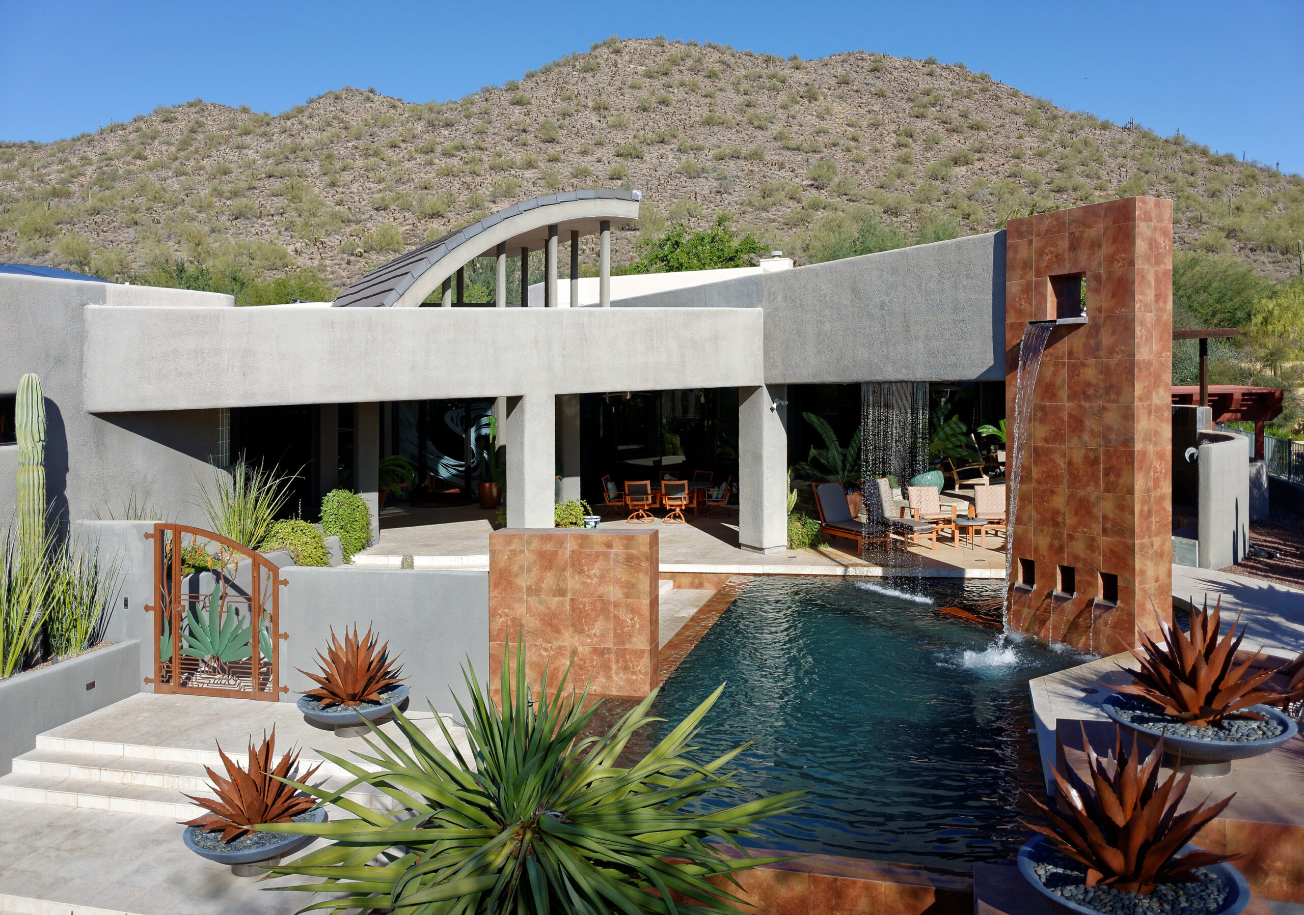 white desert home in front of mountains freshly painted by a painter near me